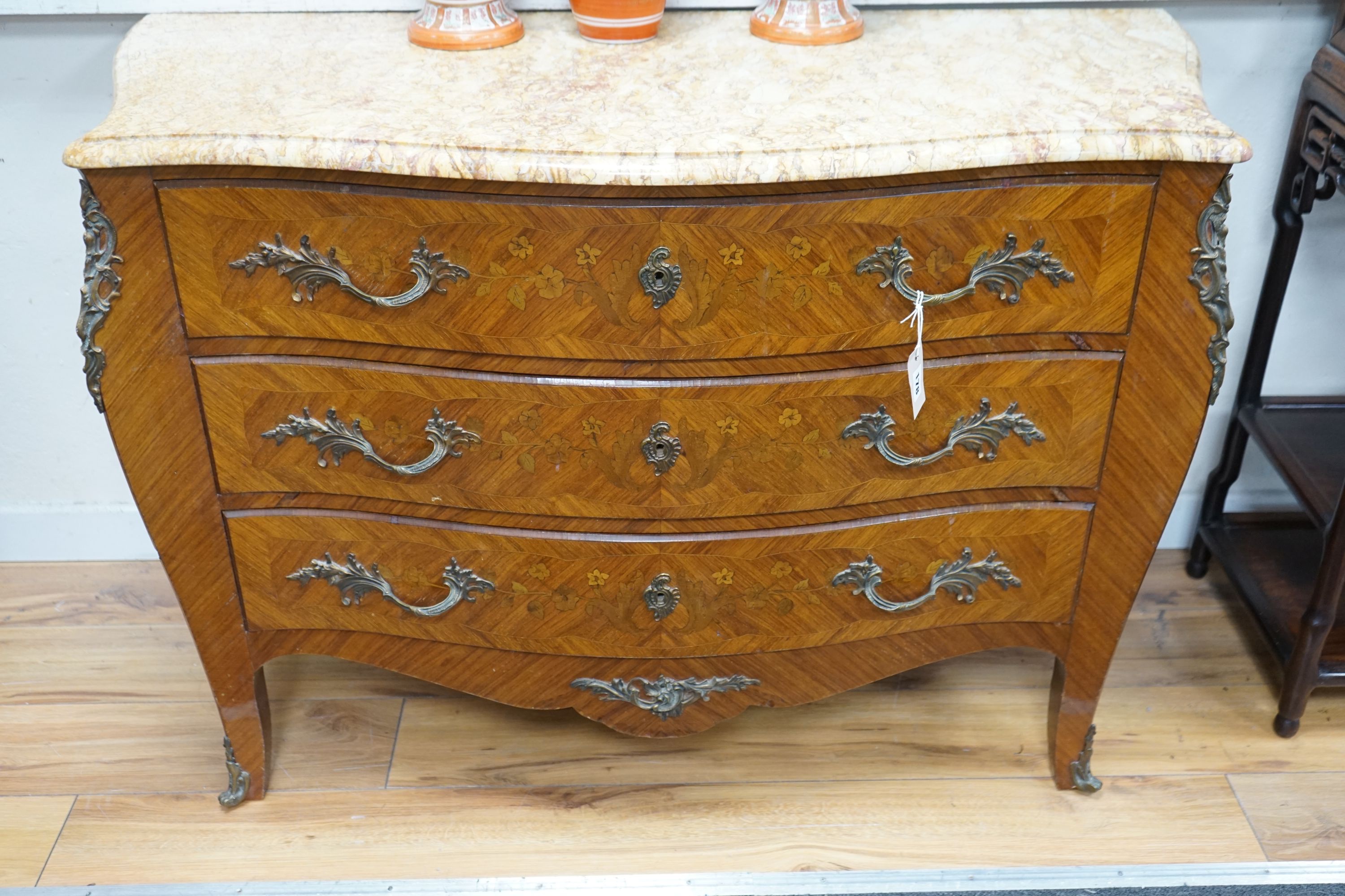 A Louis XV style marquetry inlaid kingwood serpentine marble topped bombe commode, width 120cm, depth 49cm, height 82cm